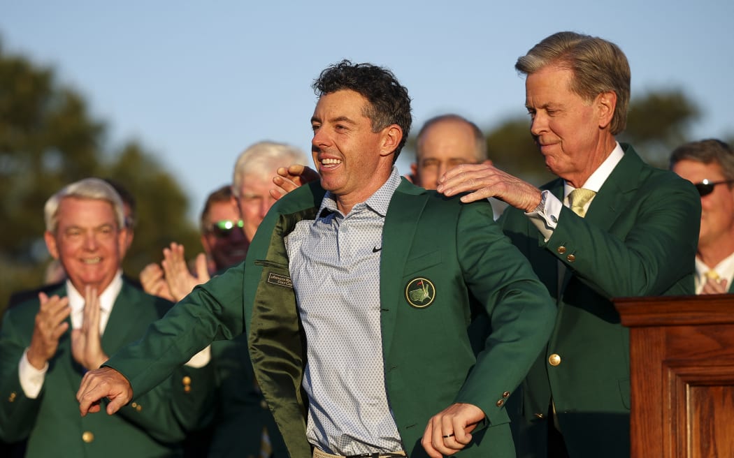 Rory McIlroy is awarded the Masters Green Jacket by Augusta National Golf Club chairman Fred Ripley after winning the Masters golf title for the second consecutive year in Augusta Georgia, April 12, 2026.
(Photo by Hector Vivas / GETTY IMAGES NORTH AMERICA / Getty Images via AFP)