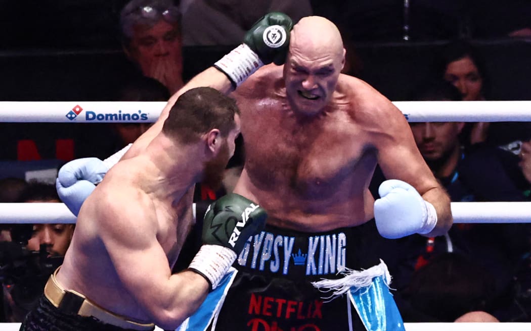 Britain's Tyson Fury (R) and Russia's Arslanbek Makhmudov exchange punches.