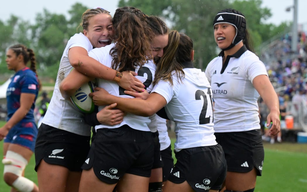 Black Ferns players celebrate a try.