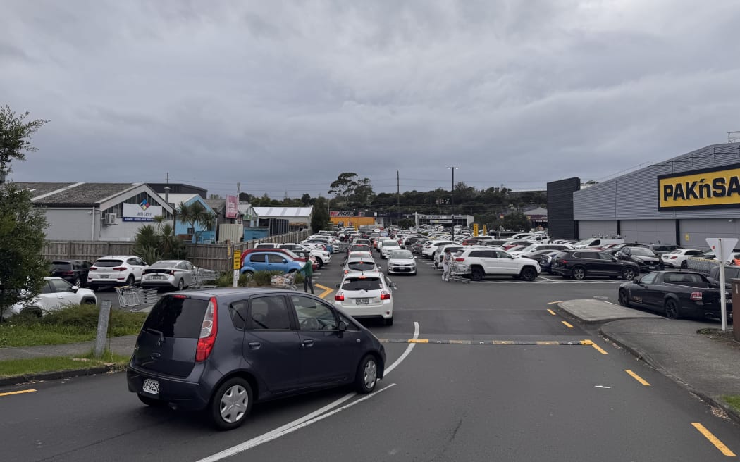 Customers queue in the carpark at Pak'nSave Wairau Road.