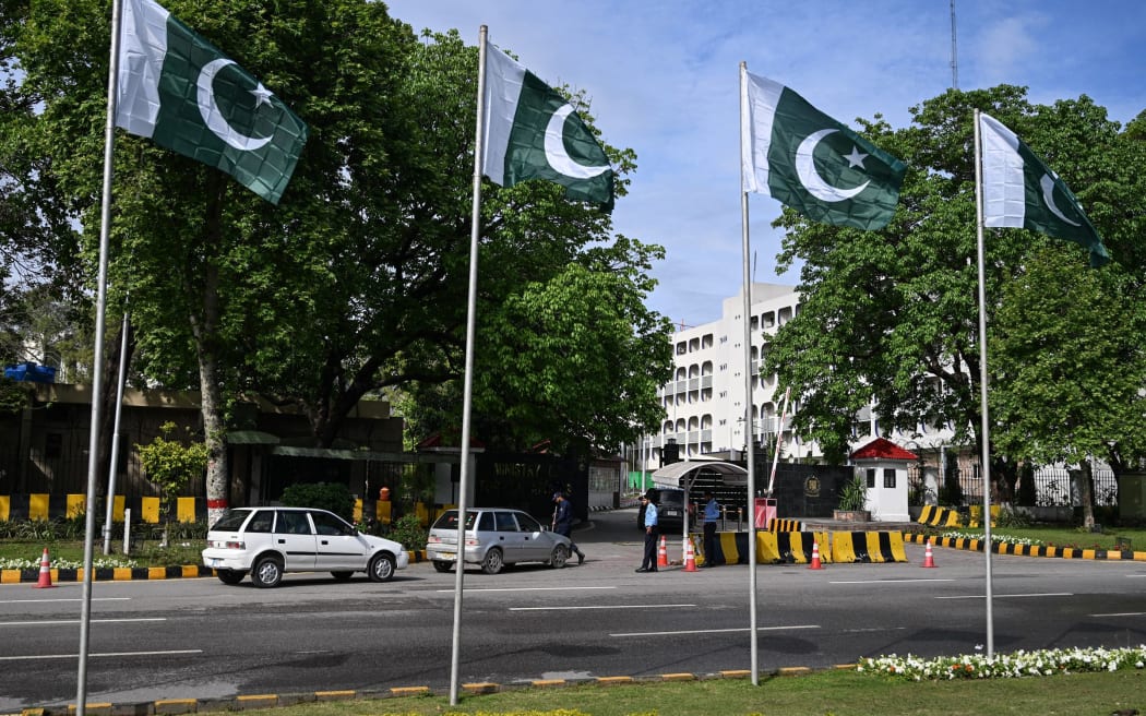 Security personnel inspect vehicles entering the Foreign Ministry office in Islamabad.