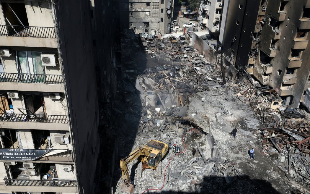Lebanese first responders use a digger to search under the rubble at the site of an Israeli airstrike that targeted a building the day before in Beirut's Corniche al-Mazraa neighbourhood on April 9, 2026. Rescuers searched for survivors under the rubble of destroyed buildings in Beirut as Lebanon observed a day of mourning after Israeli strikes across the country killed more than 200.