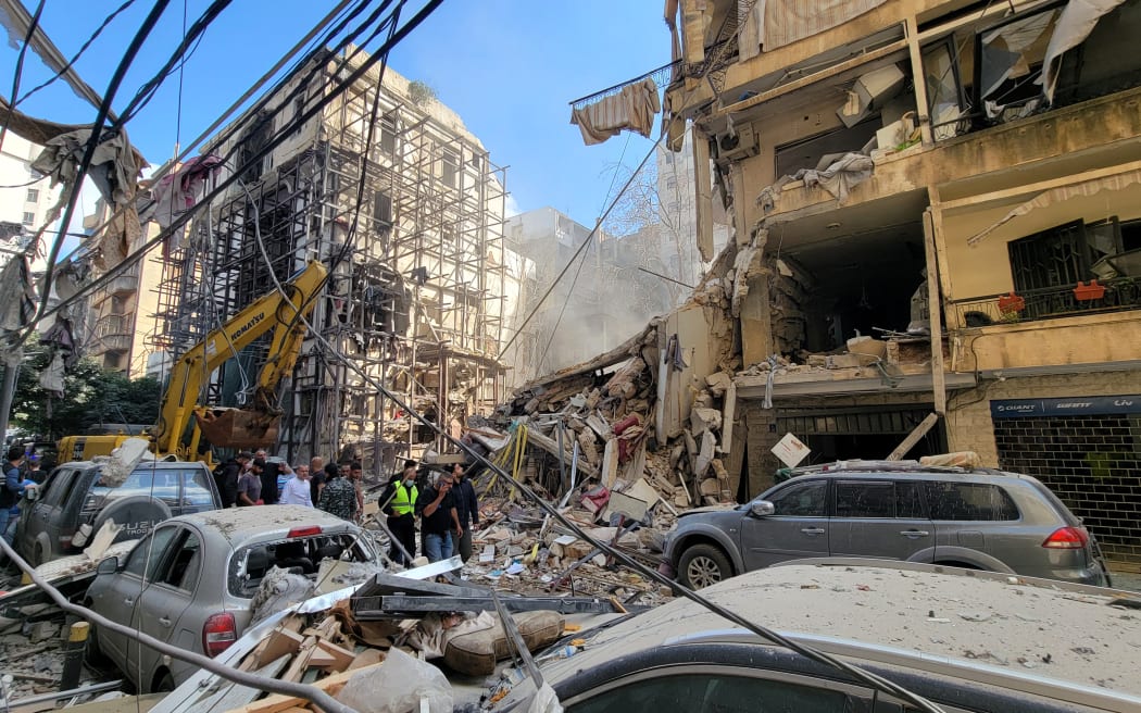 Lebanese security officials and first responders assess damage at the site of an Israeli airstrike that targeted Beirut's Ain al-Mreisseh neighbourhood on April 8, 2026. Israel launched a series of strikes in Beirut, causing panic among residents in the most violent attack on the capital since the start of the war with Hezbollah. Israel also hit Beirut's southern suburbs and southern Lebanon, where Hezbollah holds sway, in parallel with strikes on the east. Israel has insisted the two-week truce in its war with Iran does not apply to Lebanon.