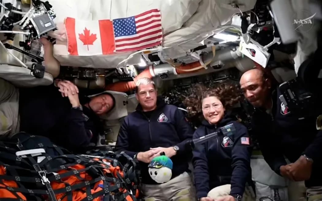 (From left) Artemis II's Reid Wiseman, Jeremy Hansen, Christina Koch, and Victor Glover take interviews from the Orion capsule in outer space.