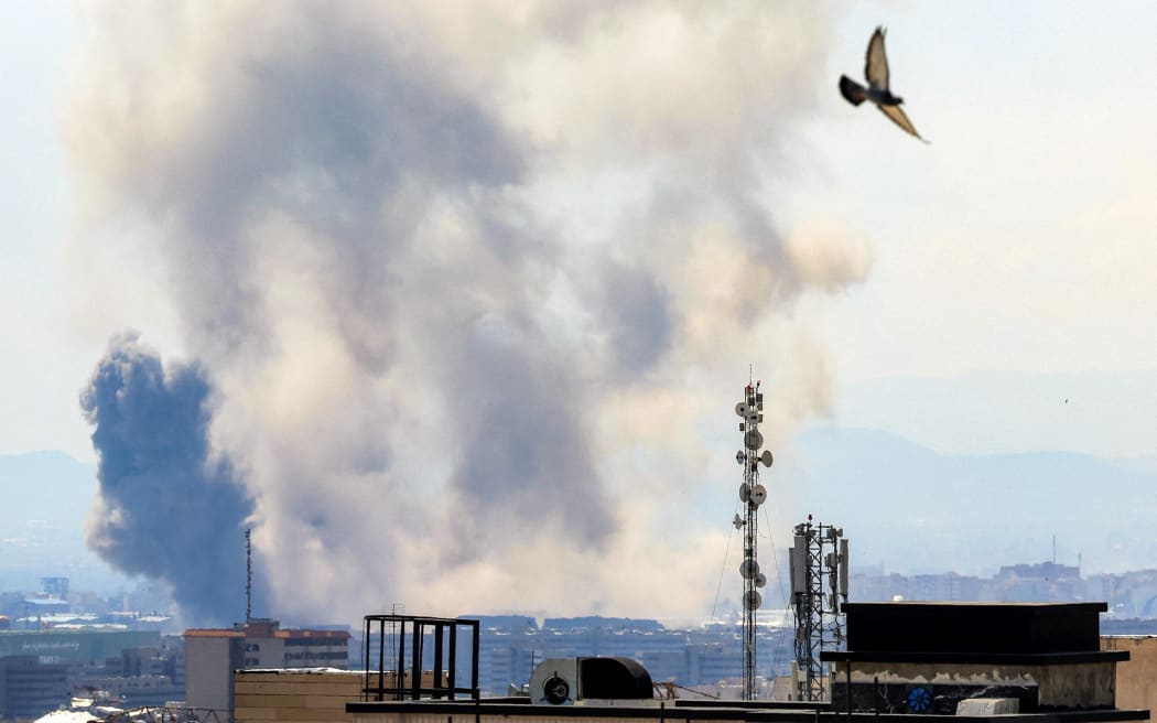 Smoke rises following strikes on Tehran on April 7, 2026. New strikes rocked Tehran on April 7 with Iran showing no sign of backing down as a US deadline loomed for it to reopen the Strait of Hormuz or have its civilian infrastructure 