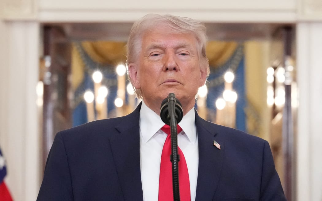 US President Donald Trump pauses as he finishes speaking during a televised address on the conflict in the Middle East from the Cross Hall of the White House in Washington, DC on April 1, 2026. President Donald Trump made his case for attacking Iran in his first nationwide address more than a month into the war, insisting the United States was close to victory as his approval rating sinks. In an evening speech from the White House, Trump broke little new ground on how the war would end and vowed two to three weeks further of 