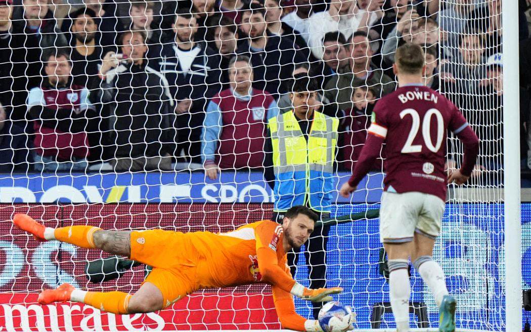 Leeds United's Brazilian goalkeeper #01 Lucas Perri saves a penalty from West Ham United's English striker #20 Jarrod Bowen in the shoot-out during the English FA Cup quarter final football match between West Ham United and Leeds United at the London Stadium in east London on April 5, 2026. (Photo by CARLOS JASSO / AFP) / RESTRICTED TO EDITORIAL USE. No use with unauthorized audio, video, data, fixture lists, club/league logos or 'live' services. Online in-match use limited to 120 images. An additional 40 images may be used in extra time. No video emulation. Social media in-match use limited to 120 images. An additional 40 images may be used in extra time. No use in betting publications, games or single club/league/player publications. /