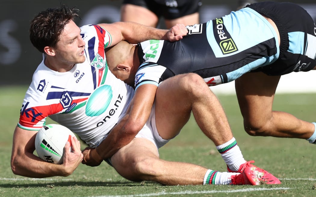 Luke Metcalf of the Warriors is tackled during the match between Cronulla-Sutherland Sharks v One NZ Warriors.