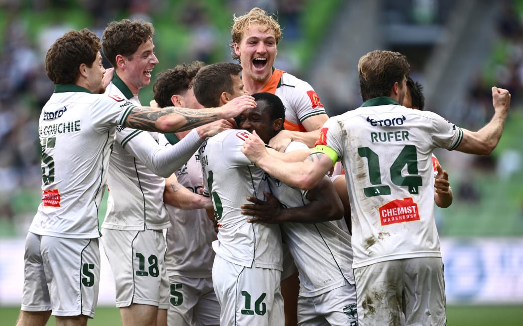 Sander Kartum of the Phoenix (centre) celebrates scoring a goal with teammates during the A-League Men’s Round 23 match between Melbourne Victory and the Wellington Phoenix at AAMI Park in Melbourne, Sunday, April 5, 2026. (AAP Image/Joel Carrett/Photosport)