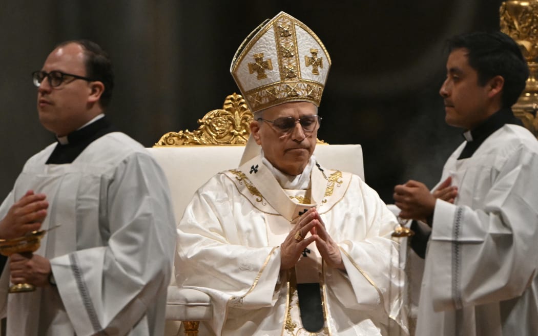 Pope Leo XIV presides over the Easter vigil as part of the Holy Week celebrations, at St Peter's basilica in the Vatican on April 4, 2026. (Photo by Andreas SOLARO / AFP)
