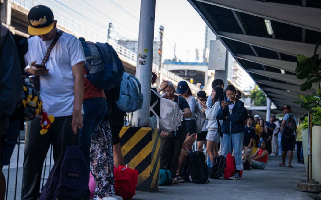 Manila's bus stops are becoming increasingly busy as people flock to public transport.