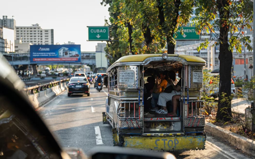 A jeepney full of passengers, in Quezon City in the Philippines.