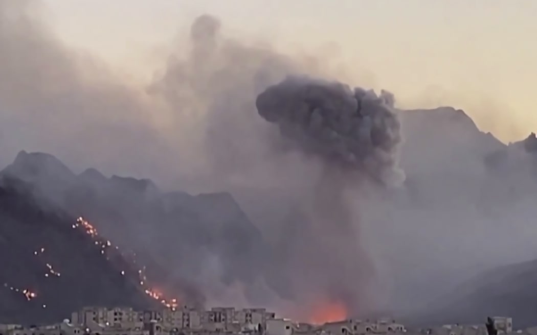 This video grab taken on April 3, 2026, from undated UGC images shared on social media on April 1, 2026, shows thick plumes of smoke rising following airstrikes in Baharestan, in Iran's central Isfahan province.
