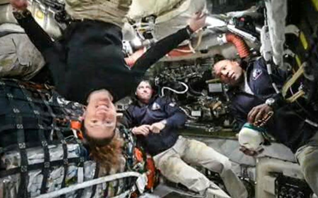 This screen grab from NASA's feed released on April 3, 2026, shows the four Artemis II crew members (L-R) Canadian Space Agency (CSA) astronaut Jeremy Hansen, Artemis II mission specialist (hidden), NASA astronauts Reid Wiseman, Artemis II commander, Christina Koch, Artemis II mission specialist and Victor Glover, Artemis II pilot as they head to orbit the Moon for the first time in more than half a century. The spacecraft lifted off from Kennedy Space Center in Florida at 18:35 EDT the previous day. (Photo by Handout / NASA TV / AFP) / RESTRICTED TO EDITORIAL USE - MANDATORY CREDIT "AFP PHOTO / NASA" - HANDOUT - NO MARKETING NO ADVERTISING CAMPAIGNS - DISTRIBUTED AS A SERVICE TO CLIENTS