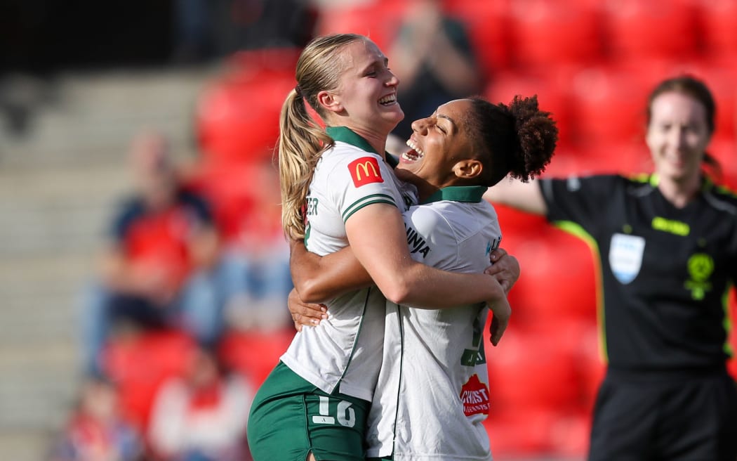 Marisa Van Der Meer (L) of the Phoenix celebrates a goal with team mate Lucia Leon.