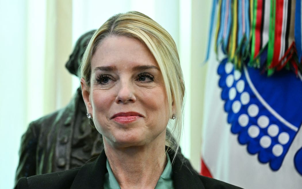 US Attorney General Pam Bondi listens as US President Donald Trump (out of frame) speaks before swearing in the new Secretary of Homeland Security Markwayne Mullin in the Oval Office of the White House in Washington, DC, on March 24, 2026. The US Senate on Monday confirmed Mullin as the new chief of the Department of Homeland Security (DHS), the agency reeling from a partial government shutdown as it works to enforce President Donald Trump's immigration crackdown. (Photo by Jim WATSON / AFP)