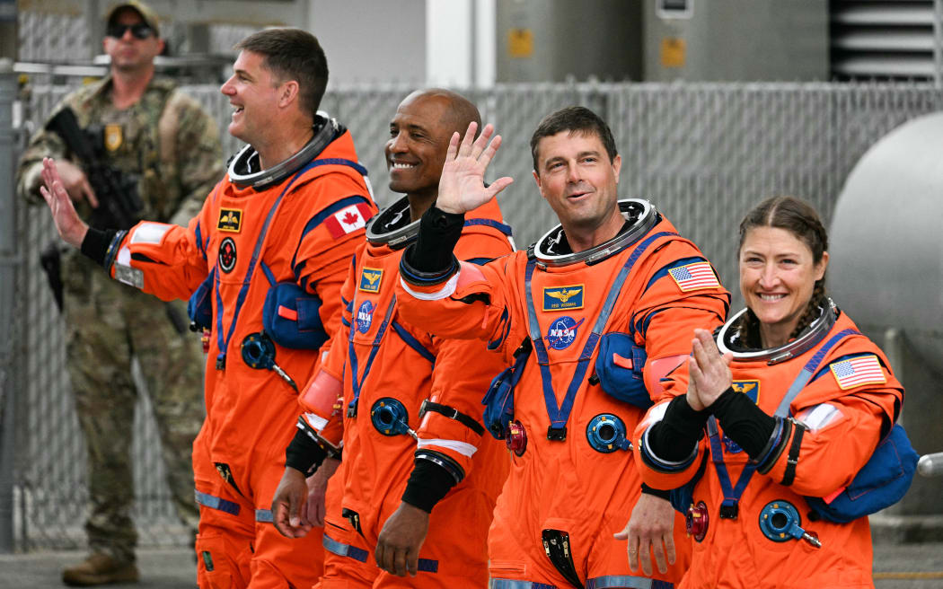 (L/R) Canadian Space Agency (CSA) astronaut Jeremy Hansen, Artemis II mission specialist, NASA astronauts Victor Glover, Artemis II pilot, Reid Wiseman, Artemis II commander, and Christina Koch, Artemis II mission specialist, walk out before traveling to the launch pad to board the Space Launch System (SLS) rocket for the Artemis II crewed lunar mission at Kennedy Space Center in Cape Canaveral, Florida, on April 1, 2026. On Wednesday three men and one woman are set to embark on the first crewed journey to the Moon since 1972, a landmark odyssey that aims to launch the US into a new era of space exploration. The NASA mission dubbed Artemis 2 has been years in the making after facing repeated setbacks, but is finally scheduled to take off from Florida as early as April 1 at 6:24 pm (2224 GMT). (Photo by Jim WATSON / AFP)