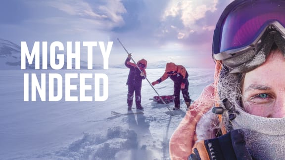 A woman in warm clothing, goggles, and a face covering stands on the ice in Antarctica. Two other women examine beneath the ice behind her. To the left of them all, the text reads: