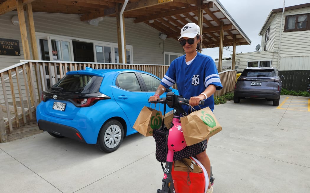 Gigi Joyce said she's sold her car after the spike in fuel costs and now picks up food parcels on a rented e-scooter. 