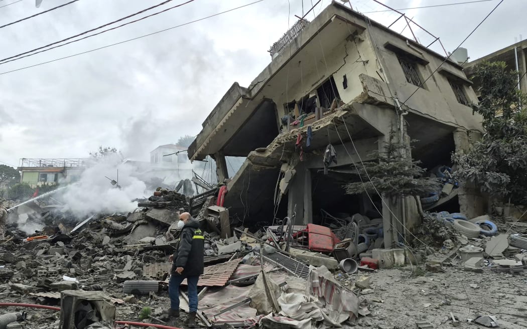 First aid responders are seen at the site of an Israeli airstrike that targeted the southern Lebanese village of Kfar Roummane on March 26, 2026. An Israeli soldier was killed in fighting in south Lebanon on March 26, the military said, after the army announced it was conducting ground operations against Iran-backed Hezbollah. In total, three Israeli soldiers have been killed in fighting in south Lebanon since Hezbollah drew the country into war by launching rocket attacks against Israel on March 2 to avenge the killing of Iran's supreme leader on February 28. (Photo by Abbas Fakih / AFP)