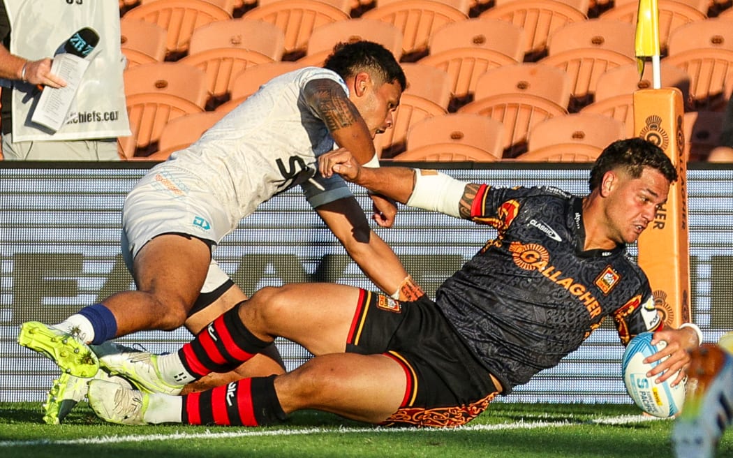 Chiefs' Quinn Tupaea scores a try.
