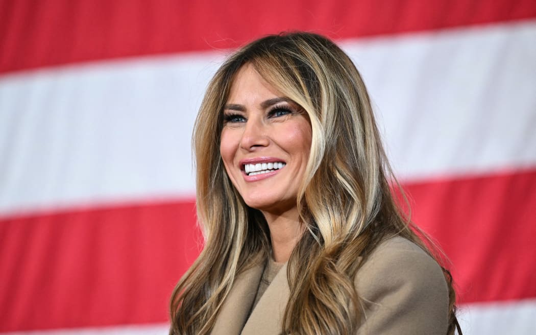 US First Lady Melania Trump smiles as US President Donald Trump (out of frame) speaks to members of the military and their families at Fort Bragg, North Carolina on February 13, 2026. Trump will meet on Friday with the special forces soldiers who captured Venezuelan leader Nicolas Maduro in a deadly raid in Caracas in January. (Photo by Mandel NGAN / AFP)