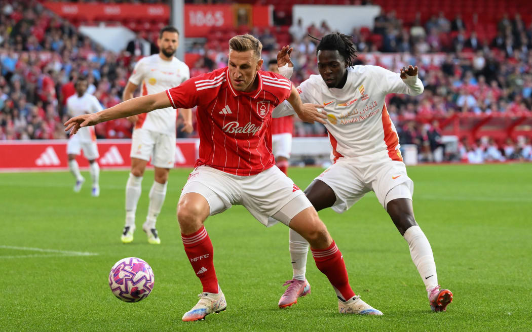 Chris Wood of Nottingham Forest battles for the ball with Mohamed Al-Thani of Al Qadsiah during the pre-season friendly match between Nottingham Forest and Al Qadsiah FC at the City Ground in Nottingham.