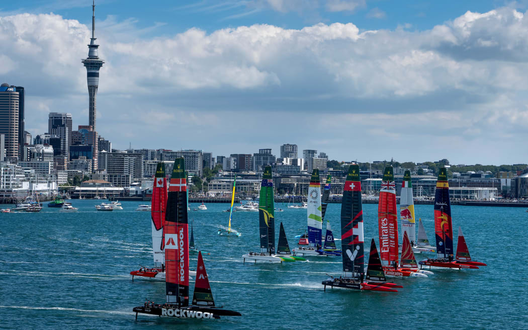 The fleet led by Spain SailGP Team helmed by Diego Botin ahead of Emirates Great Britain SailGP Team, Switzerland SailGP Team and Red Bull Italy SailGP Team start racing in front of the city skyline on Race Day 1 of The Rolex SailGP 2025 Championship ITM New Zealand Sail Grand Prix in Auckland, New Zealand. Saturday 18 January 2025. Photo: Bob Martin for SailGP. Handout image supplied by SailGP