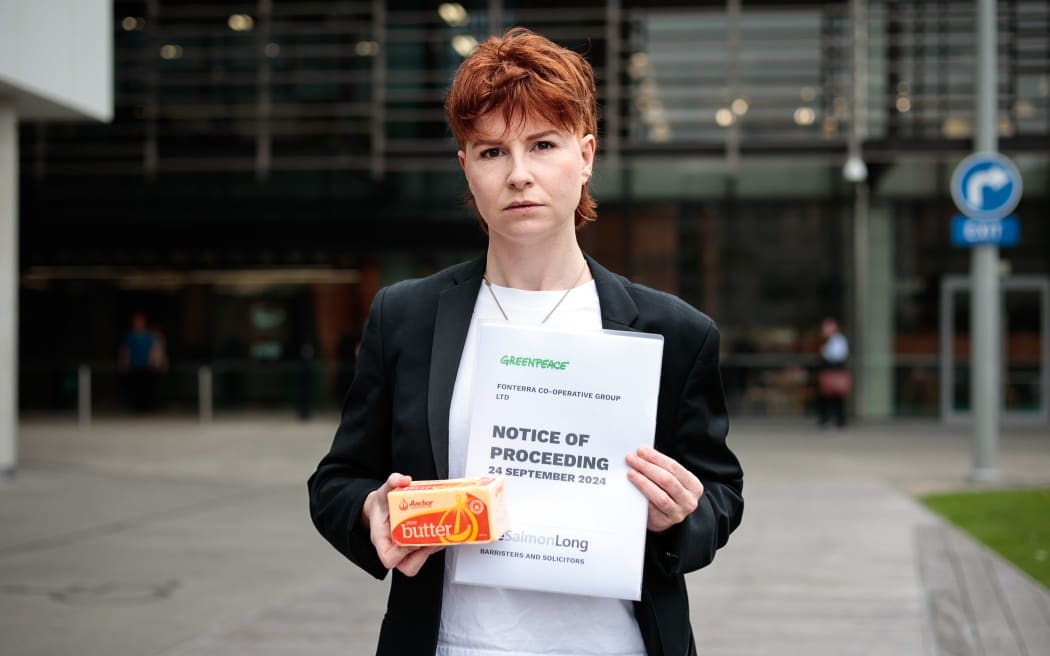 Greenpeace spokesperson Sinéad Deighton-O'Flynn serving Fonterra with a lawsuit on 30 September, 2024.