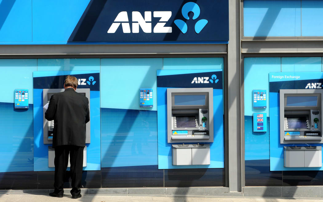 A man withdraws money from an ATM at the global headquarters of the Australia and New Zealand (ANZ) Bank in Melbourne on February, 2012.