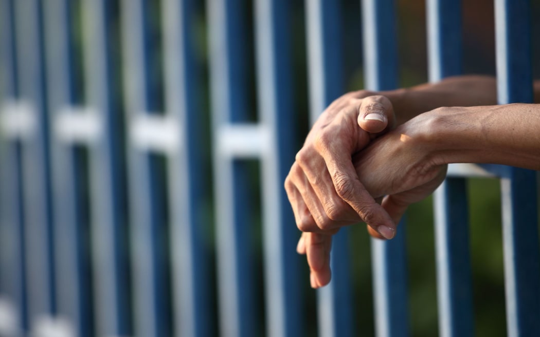 prison generic, hands in prison cell