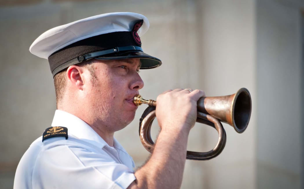 Petty Officer Musician Colin Clark playing a bugle from 1915 at a commemorative service held to mark the 100th Anniversary of the Battle of Chunuk Bair.