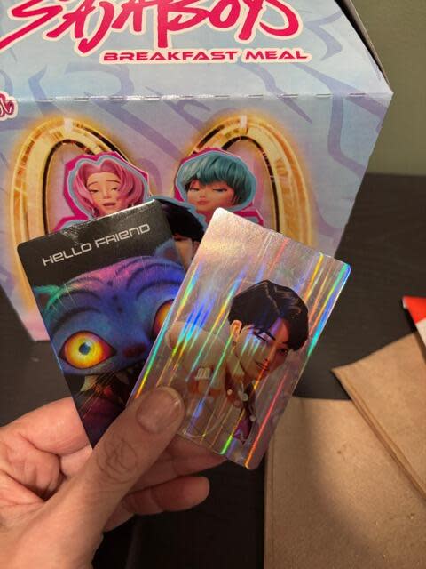 I mean, yay, holographic photo cards, but I think I would have preferred a KPop Demon Hunters figurine. Or patterned socks, like those that were given out with the Grinch meal.