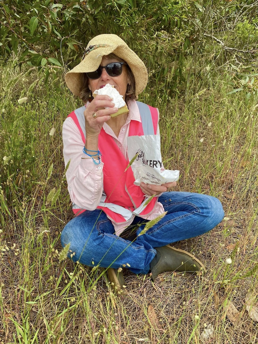 A woman eats a vanilla slice