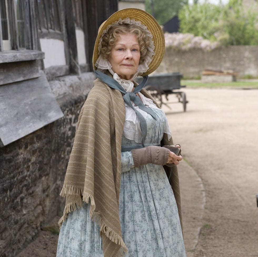 woman in historical attire standing beside a horsedrawn carriage woman in historical attire standing beside a horsedrawn carriage