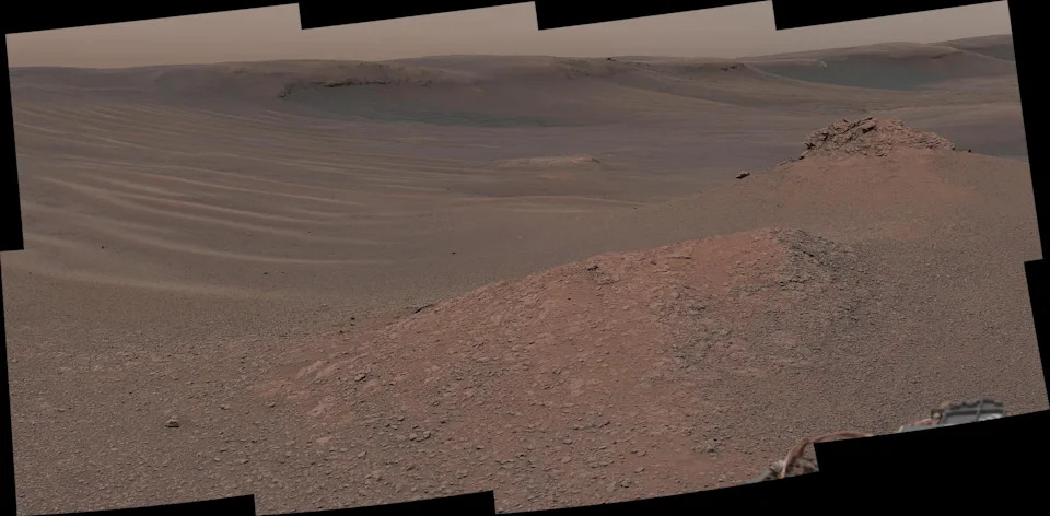 A composite image shows red and brown dusty dunes on Mars' surface.