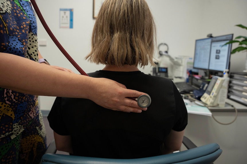 A doctor using a stethoscope on a patient.Â