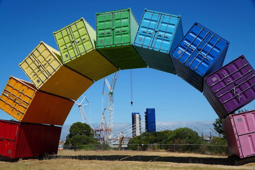 A rainbow span made of coloured shipping containers