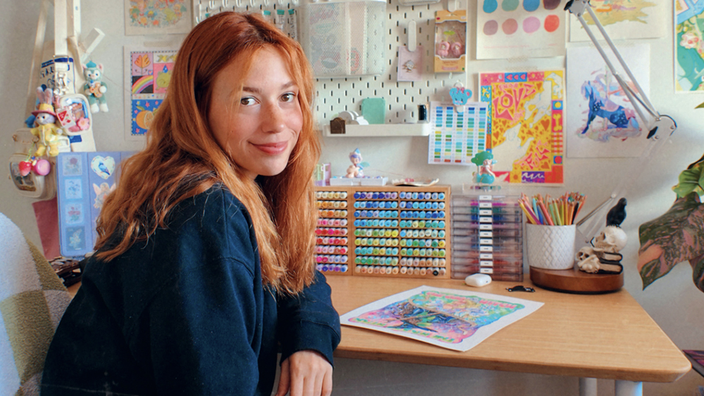 Comic artist Gretel Lusky in her art studio with a view of the sea