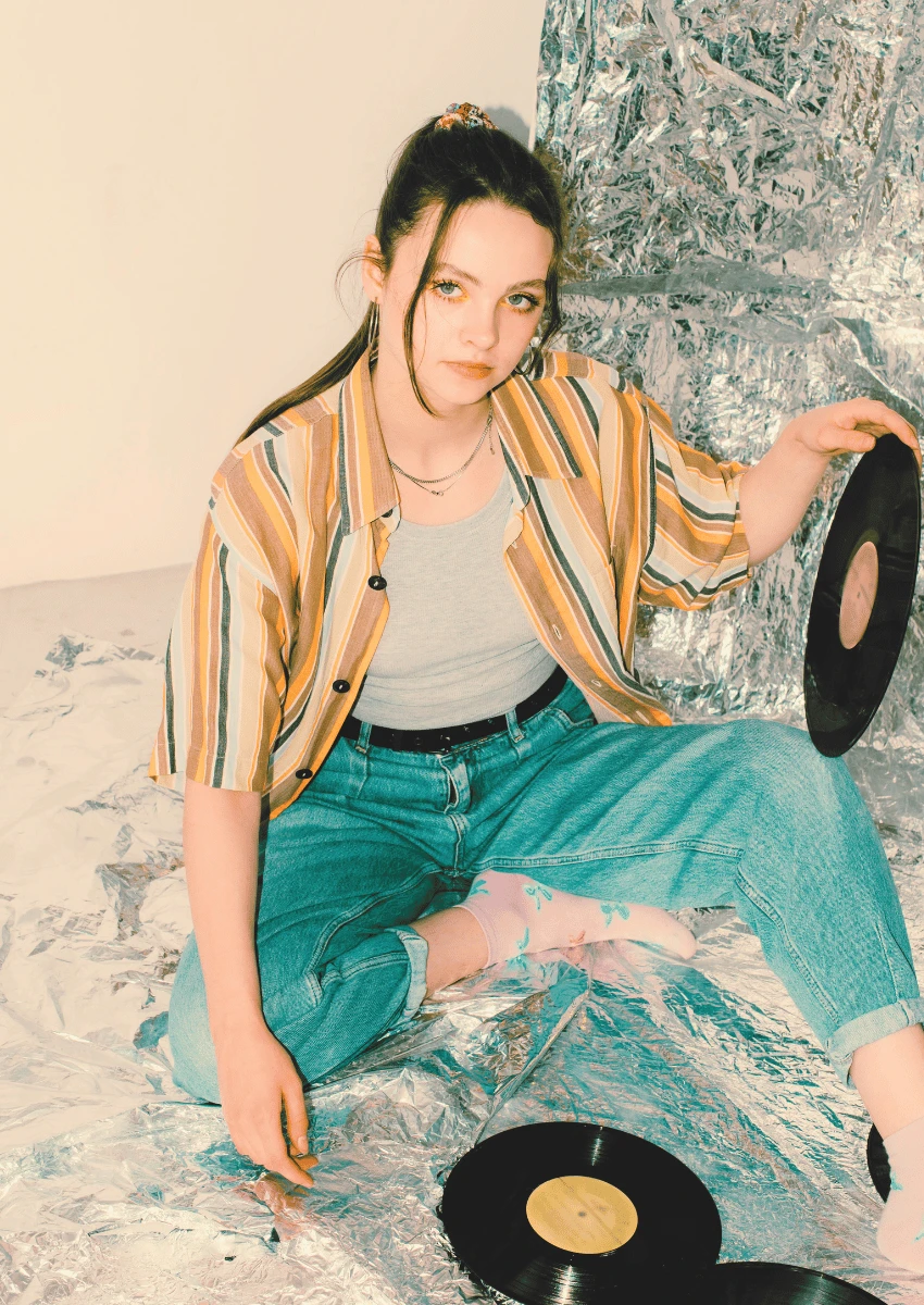 80s theme of young woman holding a vinyl record