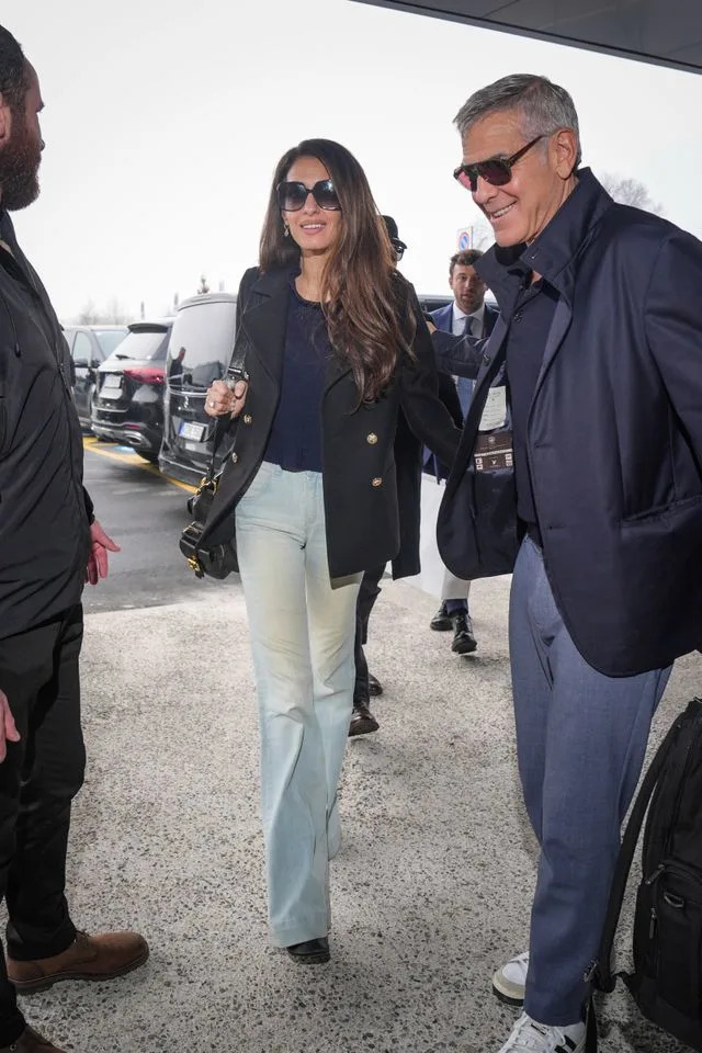 George Clooney and Amal Clooney are seen arriving at the airport on February 8, 2026 in Milan, ItalyCredit: Getty Images