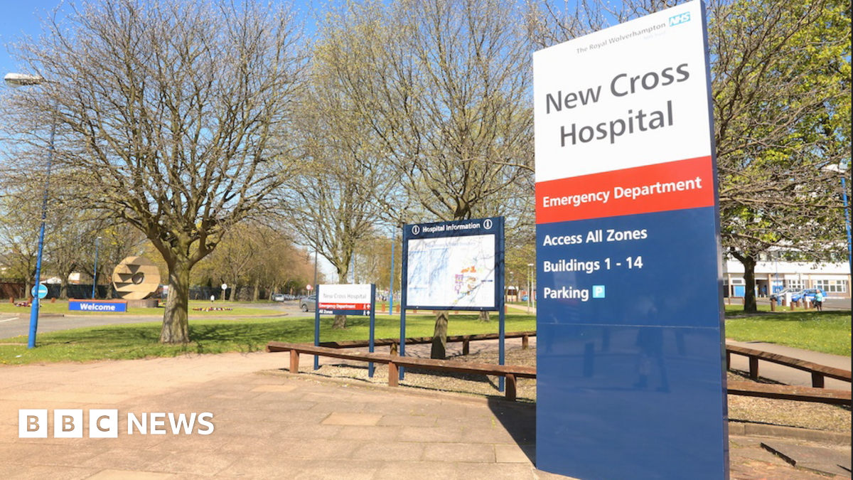 General view of the entrance of New Cross Hospial . on the right of the picture is a sign that reads New Crowss Hospital and trees can be seen in the background