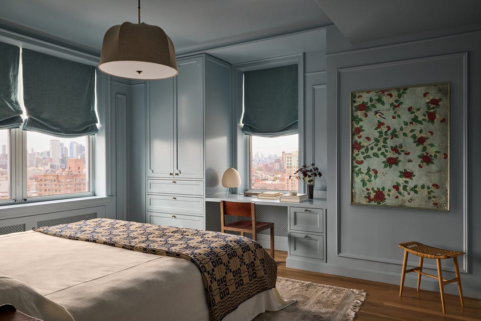 Modern bedroom with natural light and stylistic decor.