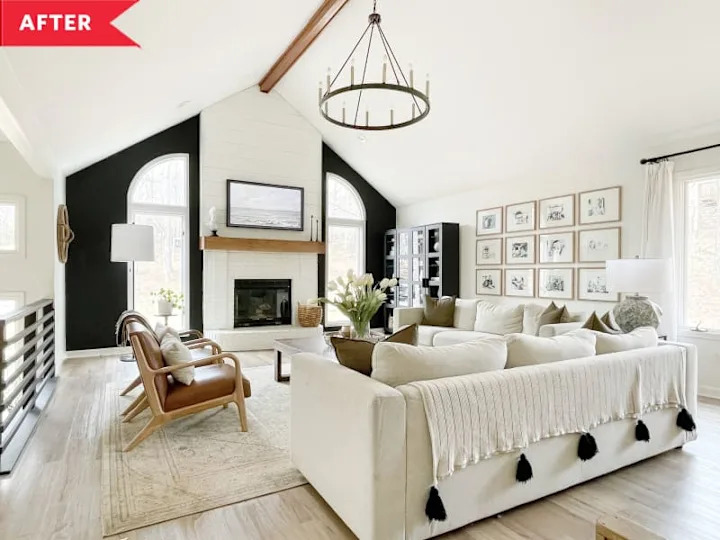 After: Large black and white living room with tall white fireplace