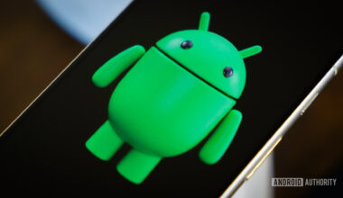 Android robot on smartphone next to other devices and accessories (3)