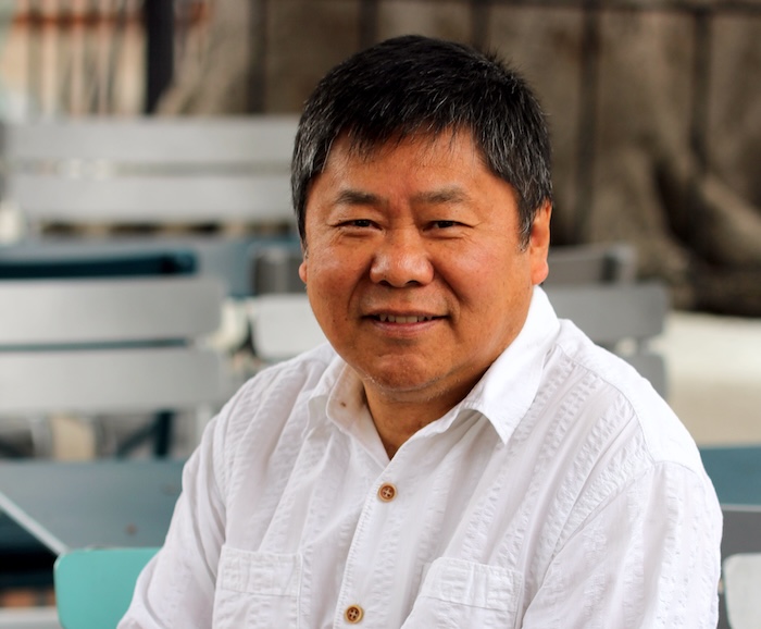 An Asian man posing for the camera