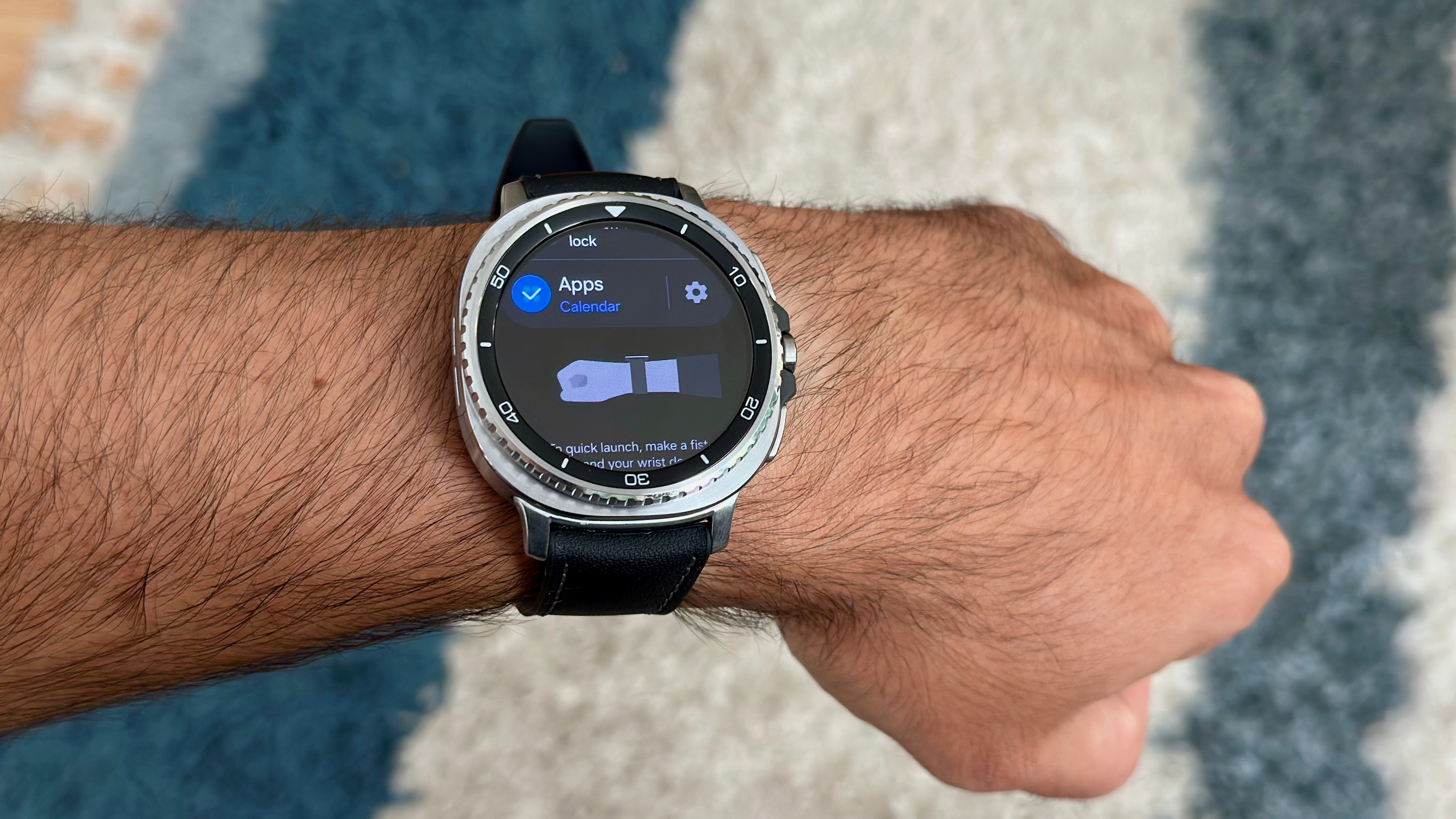 The Knock Knock gesture screen on the Samsung Galaxy Watch 8 Classic, worn on the wrist of someone doing the gesture.