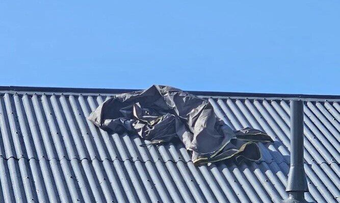  What looks to be someone’s barbecue or outdoor furniture cover ended up on this Peace St rooftop. Photo / Whakatāne Beacon