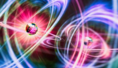 An illustration of two particles as glowing geodesic shapes surrounded be halos of pink, yellow and blue light