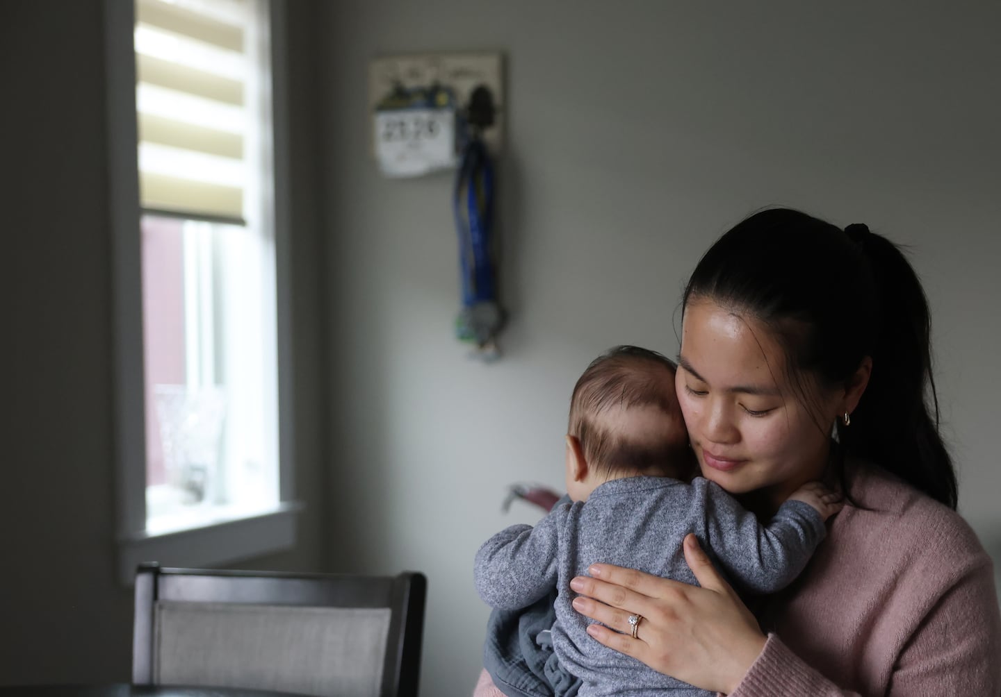 Erin Yang with her daughter at her home in Somerville.